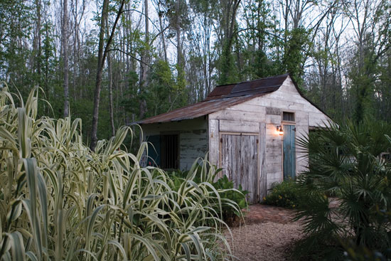 This replica of an 18th-century outbuilding, called a magazin, was made from salvaged cypress boards and houses the well pump.